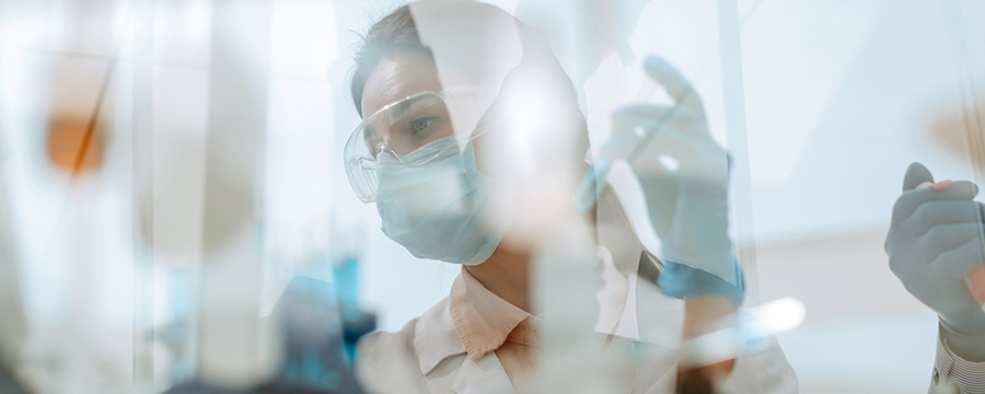 doctor handing needle with mask and gloves on